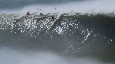 SURFERS RIDE BIG WAVE Stock Footage 128941967