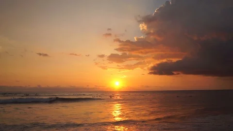 Surfers ride at orange sunset over Indian Ocean Stock-Footage 108791422