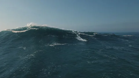 Surfers ride powerful waves in the beautiful ocean of Portugal Stock Footage 321501203