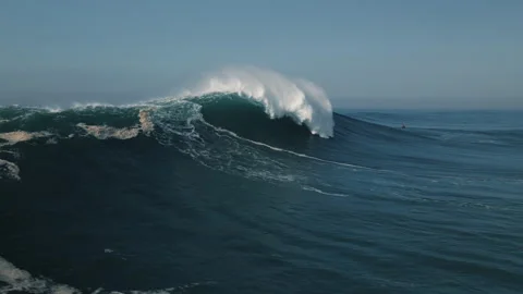 Surfers ride powerful waves in the beautiful ocean of portugal Stock Footage 321502250