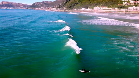 Surfers ride waves on the Cape coastline Stock Footage 340558084