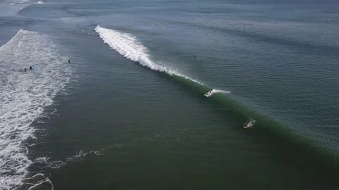 Surfers ride the waves Видео 140399765