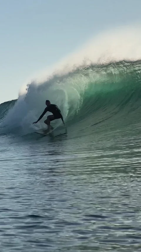 Surfers rides a powerful ocean wave.Vertical video Stock Footage 300746268