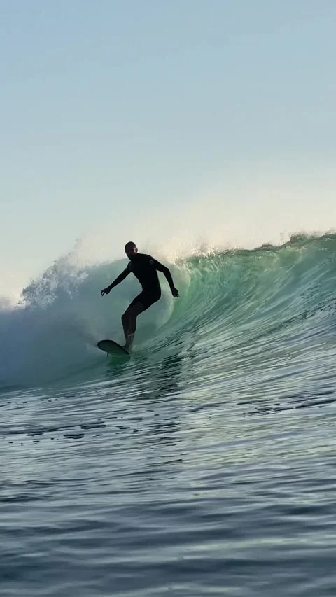 Surfers rides a powerful ocean wave.Vertical video Stock Footage 300746349