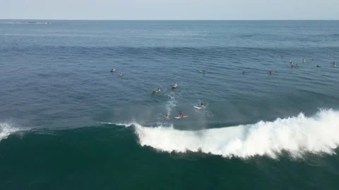 Surfers riding a big wave while others wait their turn. Stock Footage 155080963