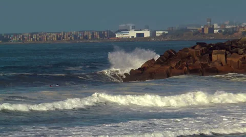 Surfers riding  big waves at cabo de  sines in portugal Stock Footage 33354415