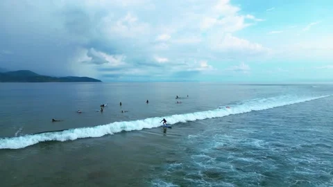 Surfers riding ocean wave under vibrant rainbow. Unique aerial view drone 스톡 동영상 344588258