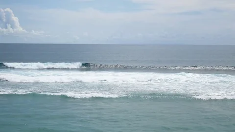 Surfers riding tsunami tidal waves at balinese surfing beach. Bali, Indonesia Stock Footage 82462989