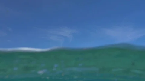 Surfers Riding Wave In Ocean Stock Footage 83044741