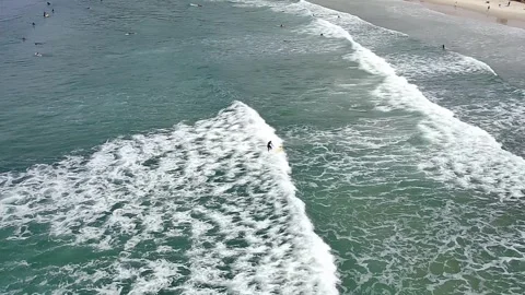 Surfers riding waves at Barra da Lagoa beach in Florianopolis. Stock Footage 314531336