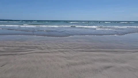 Surfers riding waves at Kuta Beach in Bali, Indonesia Vídeo Stock 285365443