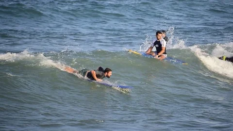 Surfers riding waves at the seashore in Spain Stock-Footage 114153246