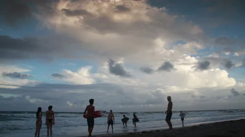 Surfers at Shoreline Contemplating Going Into Waves Stock Footage 200885045