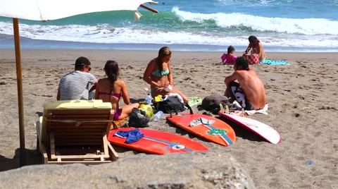 Surfers Socializing on the Beach Stock Footage 50448304