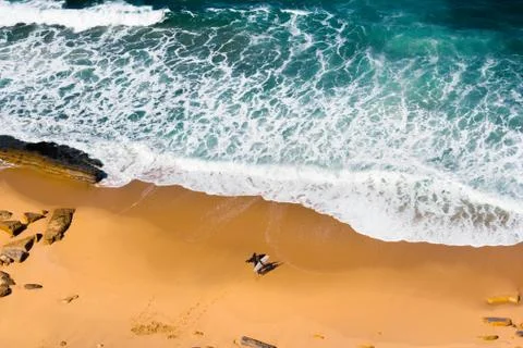 Surfers standing on beach Stock Photos
