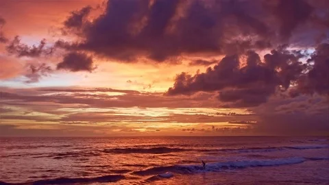 Surfers at sunset Stock Footage 76902381