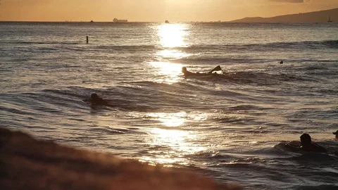 Surfers at sunset HD Stock Footage 128956336