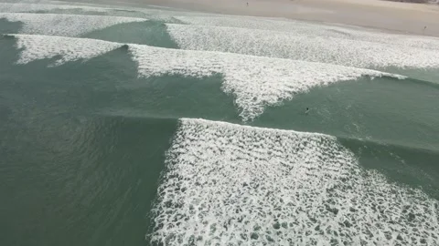 Surfers surf on waves with surfboards at the Pointe de la Torche in Brittany Stock Footage 212340955