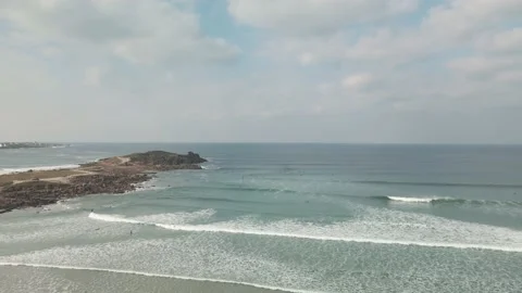 Surfers surf on waves with surfboards at the Pointe de la Torche in Brittany Stock Footage 212341037