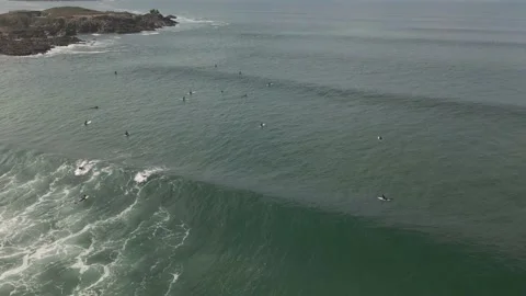 Surfers surf on waves with surfboards at the Pointe de la Torche in Brittany Stock Footage 212341275