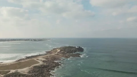 Surfers surf on waves with surfboards at the Pointe de la Torche in Brittany Stock Footage 212341276