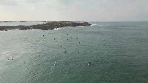 Surfers surf on waves with surfboards at the Pointe de la Torche in Brittany Stock Footage 212341659