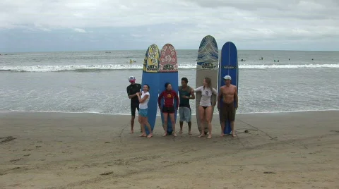 Surfers with surfboards on a beach Stock Footage 574050