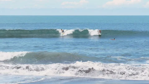 Surfers surfing big waves super slow motion Stock Footage 100089321