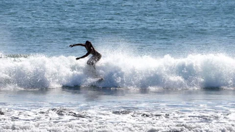 Surfers surfing big waves super slow motion Stock Footage 102670834