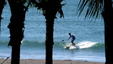 Surfers surfing big waves super slow motion Stock Footage 102670926