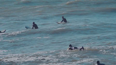Surfers surfing in ocean Stock Footage 98699874