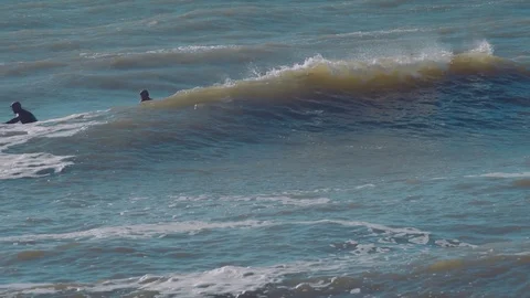 Surfers surfing in ocean Stock Footage 98699875