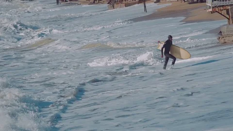 Surfers surfing in ocean Stock Footage 98700072