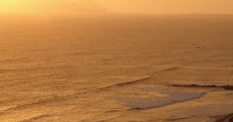 Surfers Surfing at Sunset Stock Footage 83487946