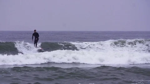 Surfers surfing on waves in slow motion Stock Footage 71564633