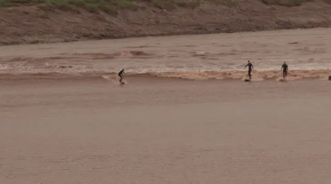 Surfers on the Tidal Bore Wave in Moncton New Brunswick. Stock Footage 68168380