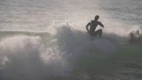 Surfers wait for waves at sunset. Stock Footage 82330306