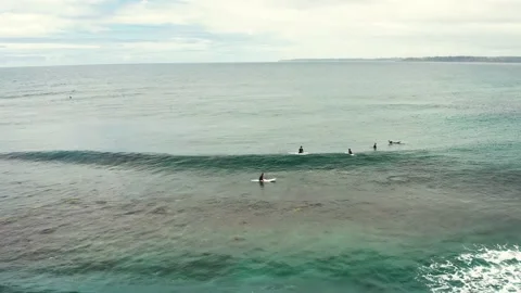 Surfers waiting for waves at the break around Green Island at Cunjurong point Stock Footage 162072145