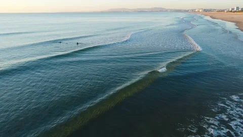 Surfers waiting Waves during Sunset at Costa da Caparica beach, Portugal Stock Footage 146101910
