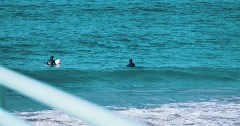 Surfers waiting for waves in turquoise ocean water Stock Footage 339519745