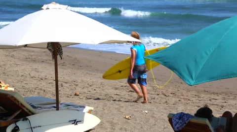 Surfers Walking Along Beach Stock Footage 50448179