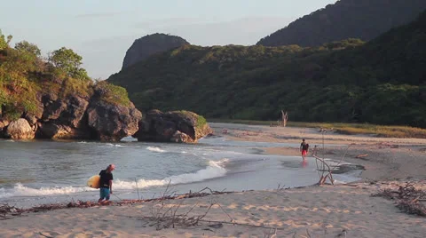 Surfers walking at the beach Stock Footage 26322502
