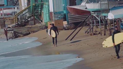 Surfers walking on the beach Stock Footage 98700052