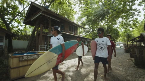 Surfers Walking with Boards Inside Dahican Beach Resort Stock Footage 237976293
