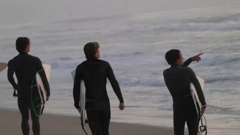 Surfers walking down beach with surf board slow motion Stock Footage 146628678