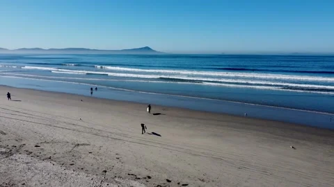 Surfers walking on the sand with their board in hand in baja california Stock Footage 233232008