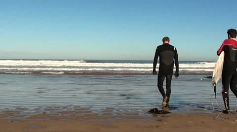 Surfers walking in sea Stock Footage 20640941