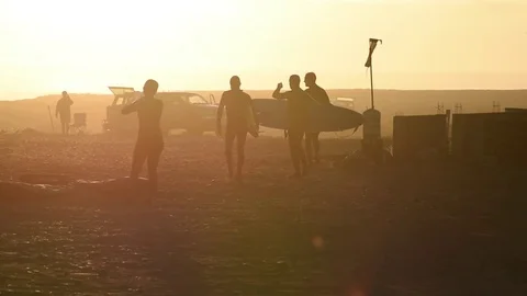 Surfers Walking Into Sunset Baja California Slow Motion Stock Footage