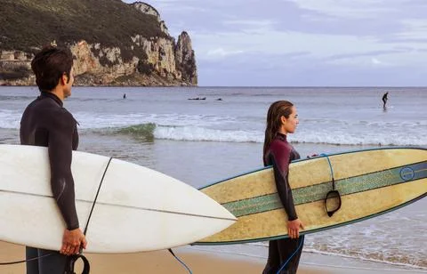 Surfers Watching the Waves in Harmony Stock Photos