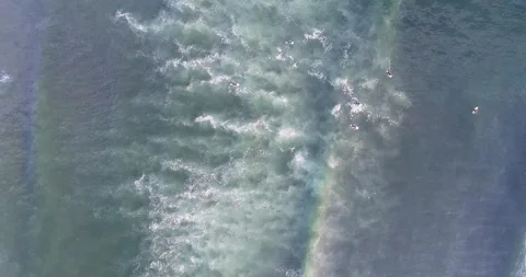 Surfers in the water on their boards waiting for the waves, aerial overhead.. Stock-Footage 288367953